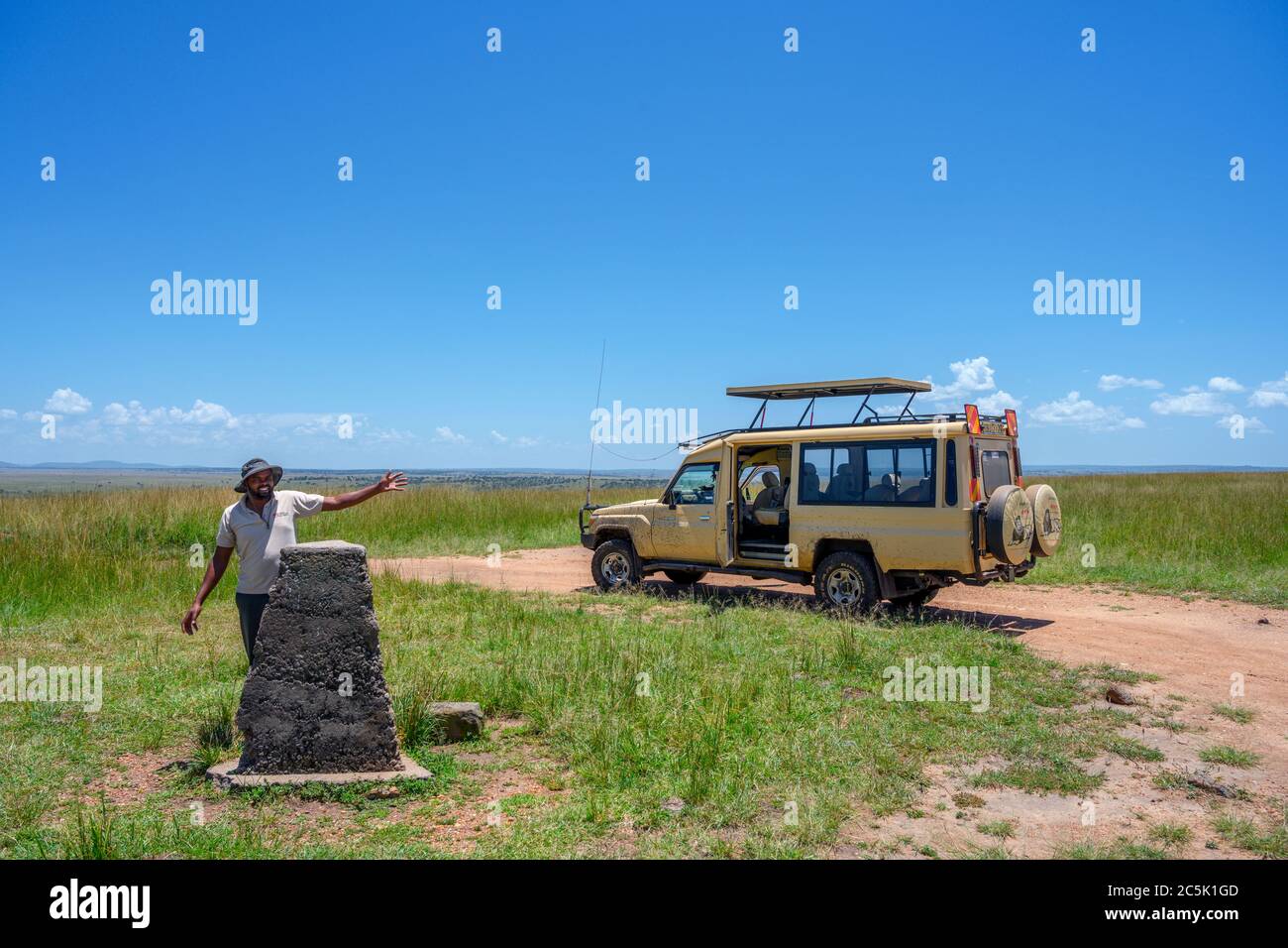 Explorer Kenya Safaris Toyota Landcruiser and driver at the border with Tanzania, Mara Triangle, Masai Mara National Reserve, Kenya, Africa Stock Photo