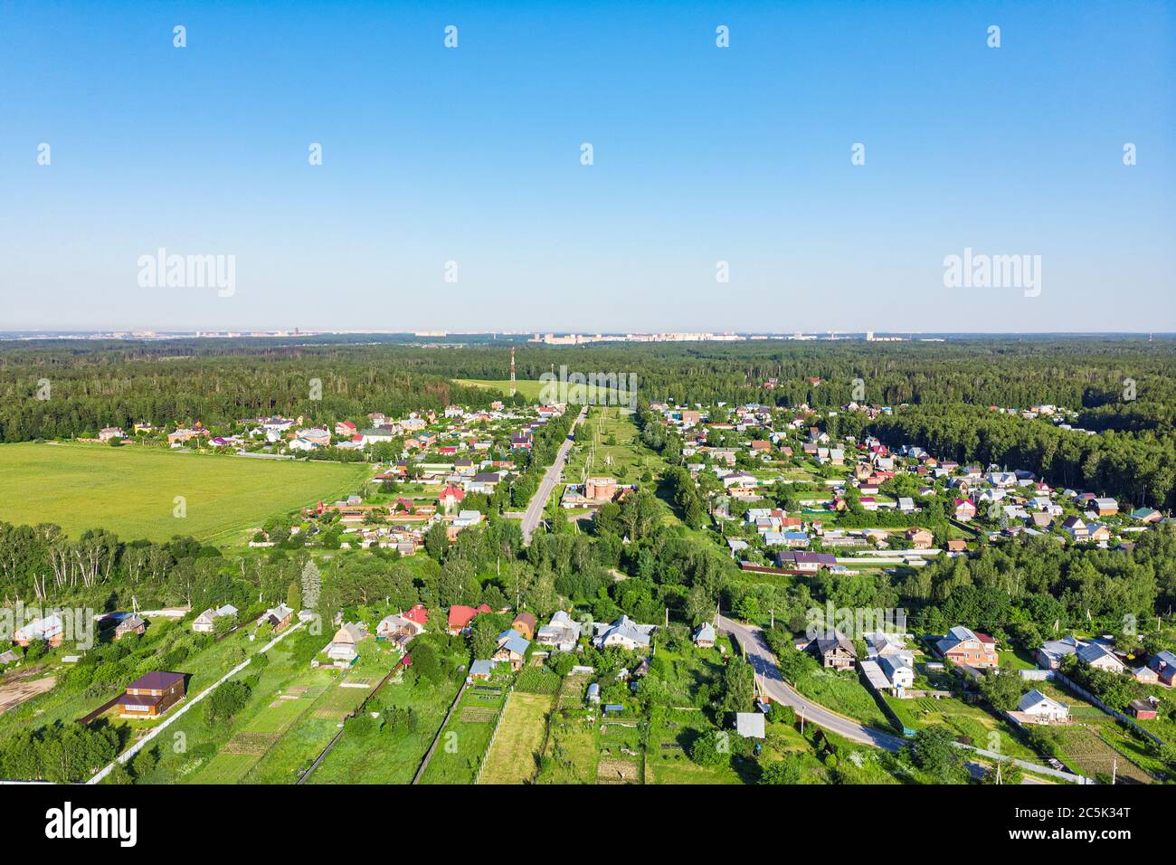 Aerial view from a drone of a rural village, fields and forests around ...