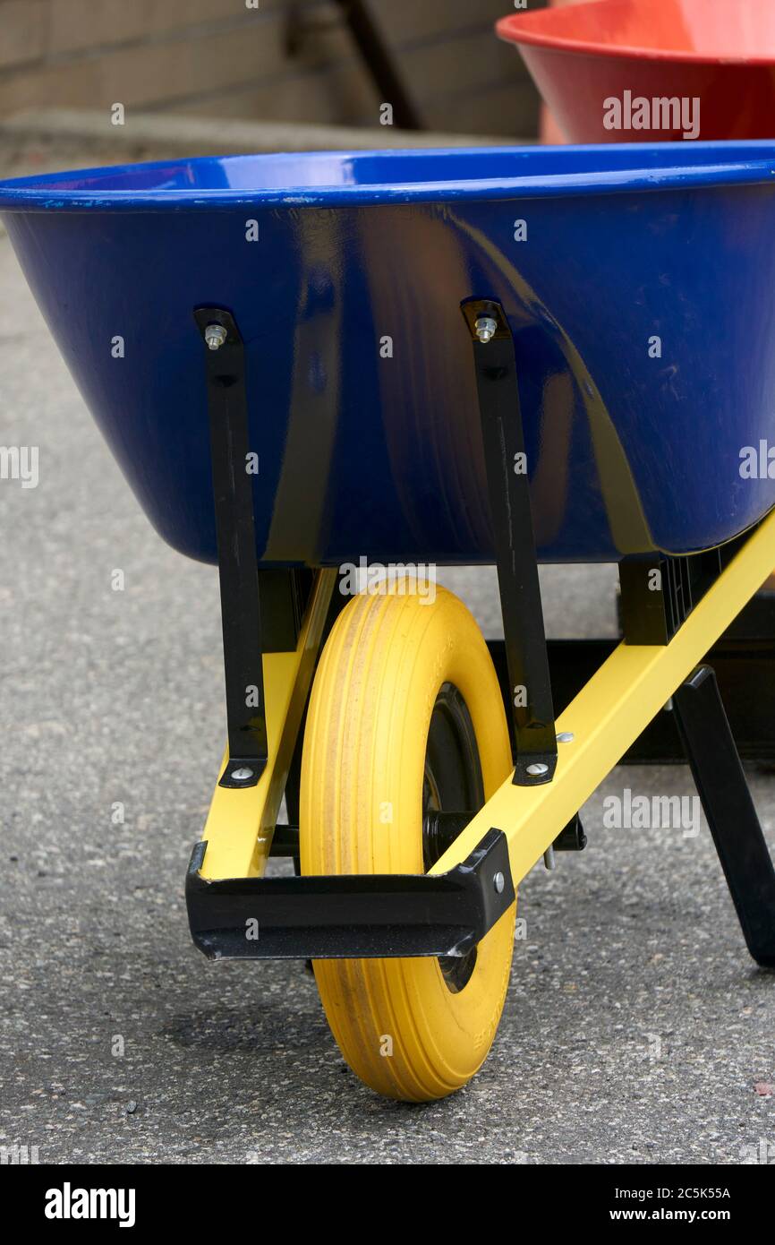 Closeup of a blue and yellow wheelbarrow, primary colors Stock Photo