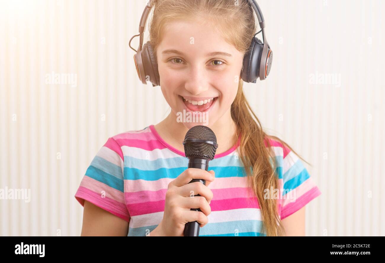 Girl in headphones singing at studio Stock Photo Alamy