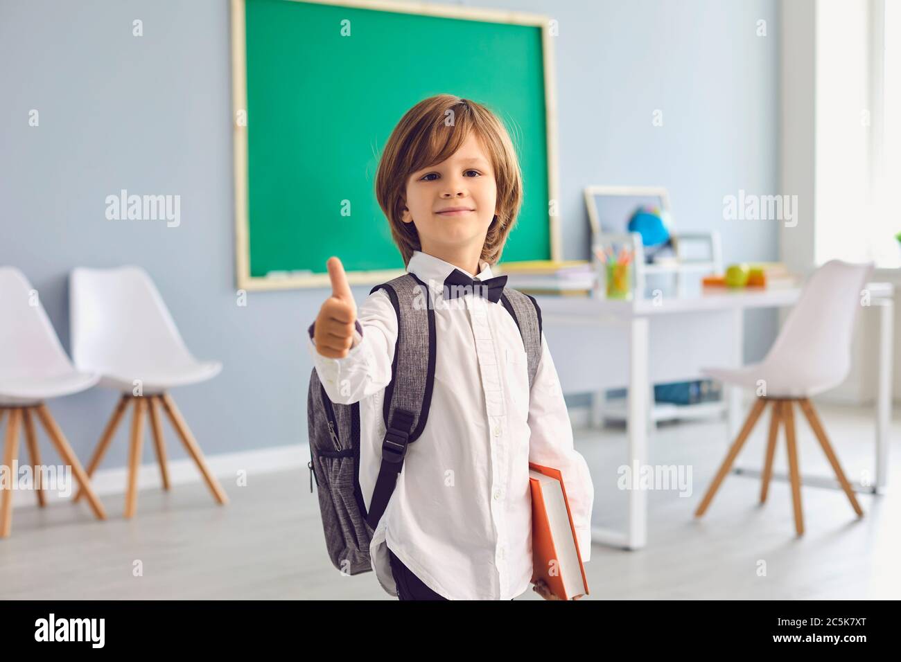 Back to school.Happy schoolboy with backpack smiling raised his thumb ...