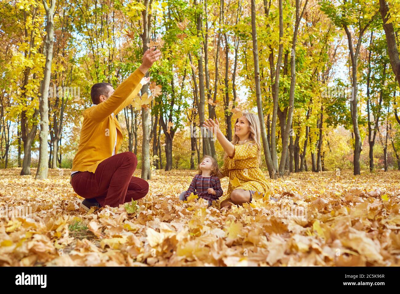 Happy family playing in the park in the fall Stock Photo - Alamy