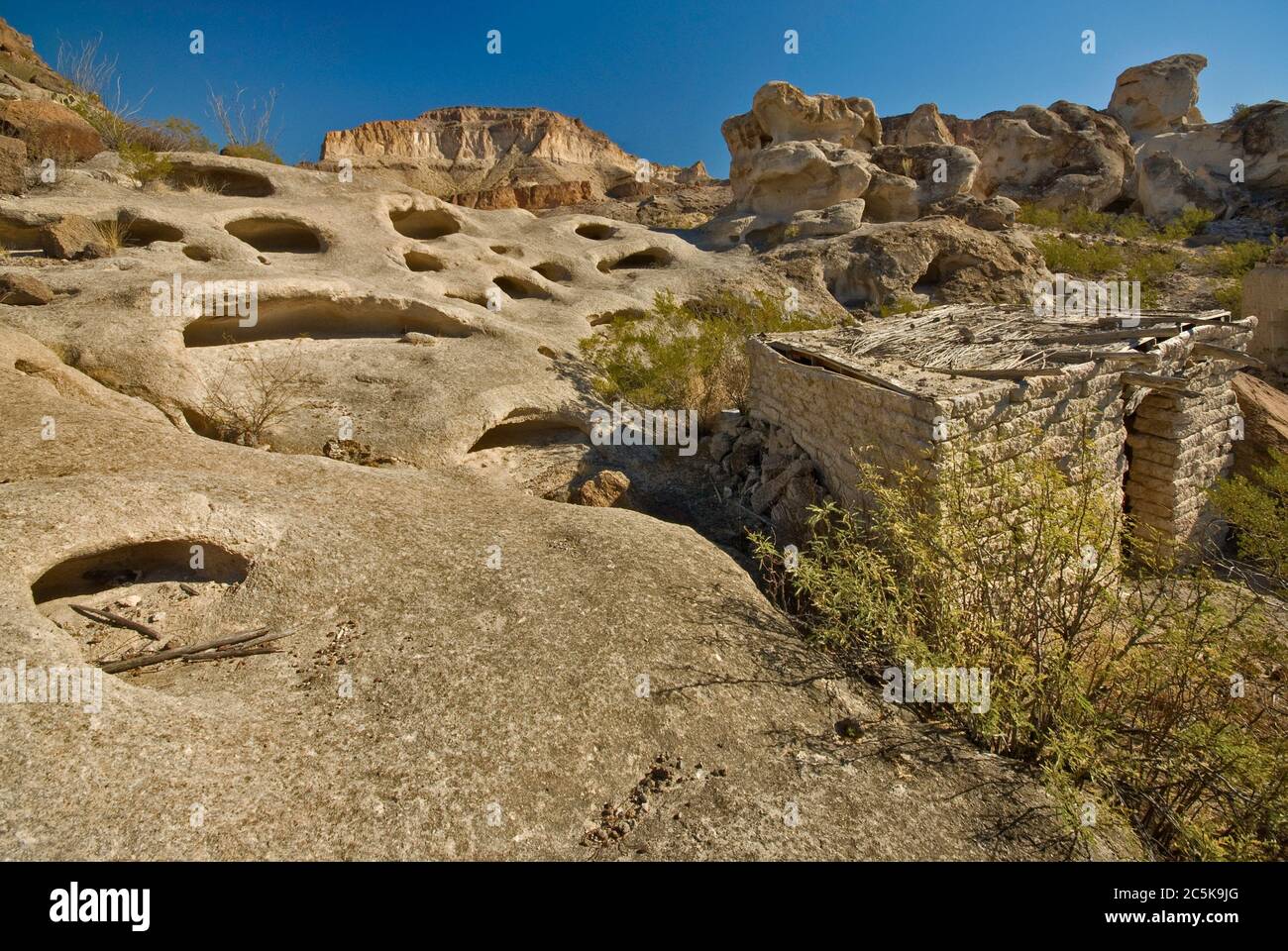 Wind caves and ruins of adobe houses at Three Dike Hill area near