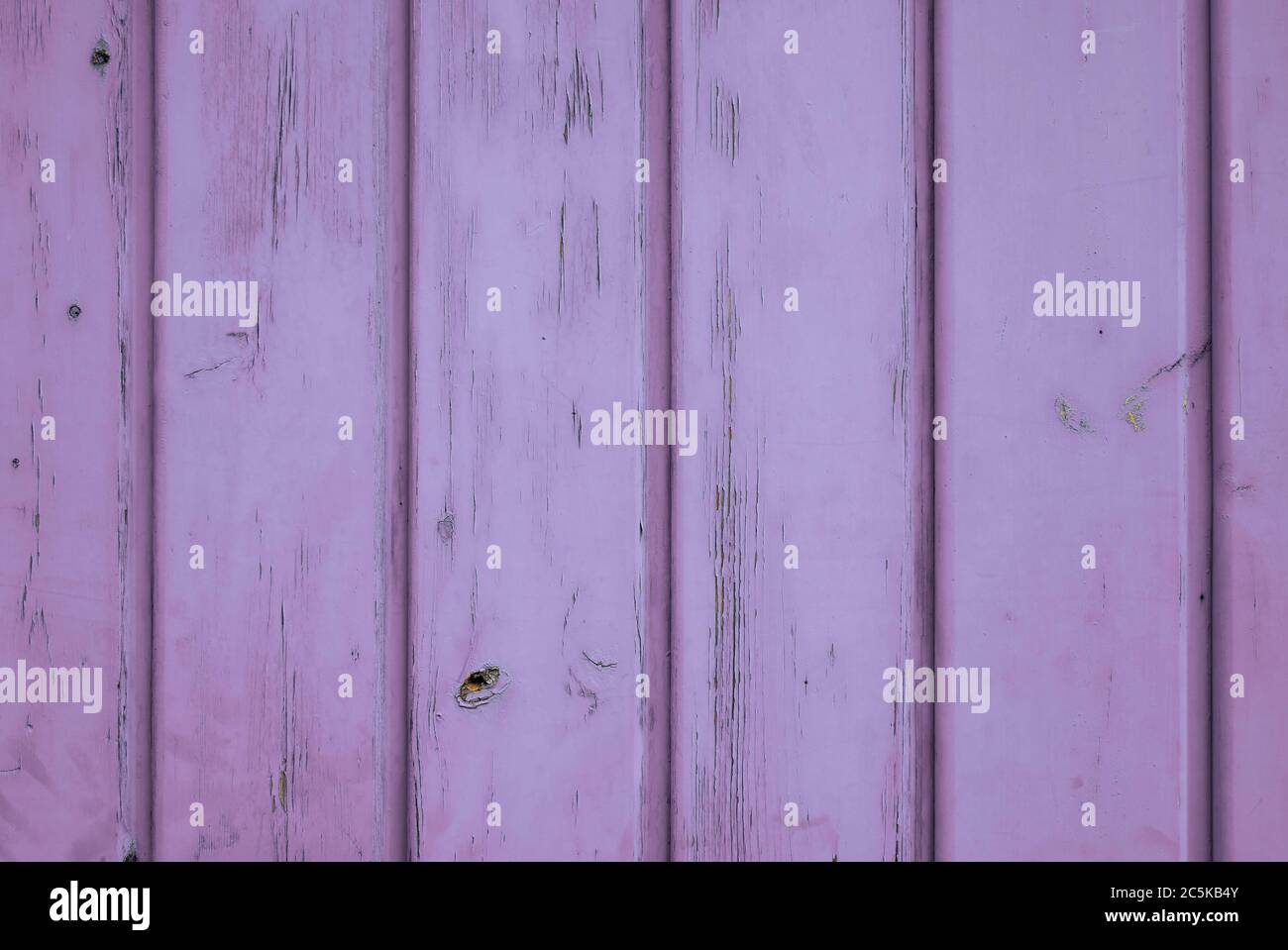 Back to the Seventies: Wooden background of purple coloured vertical planks. Cheerful 70s style retro colour. Stock Photo