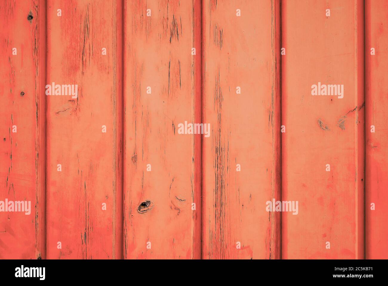 Cheerful colour background of orange weathered wood with vertical planks. Stock Photo