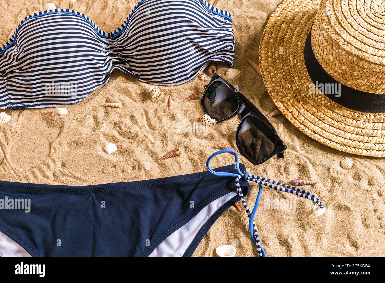 Summer bikini and accessories stylish beach set, Beach bikini summer outfit  and sea sand as background, Top View, Concept Stock Photo - Alamy