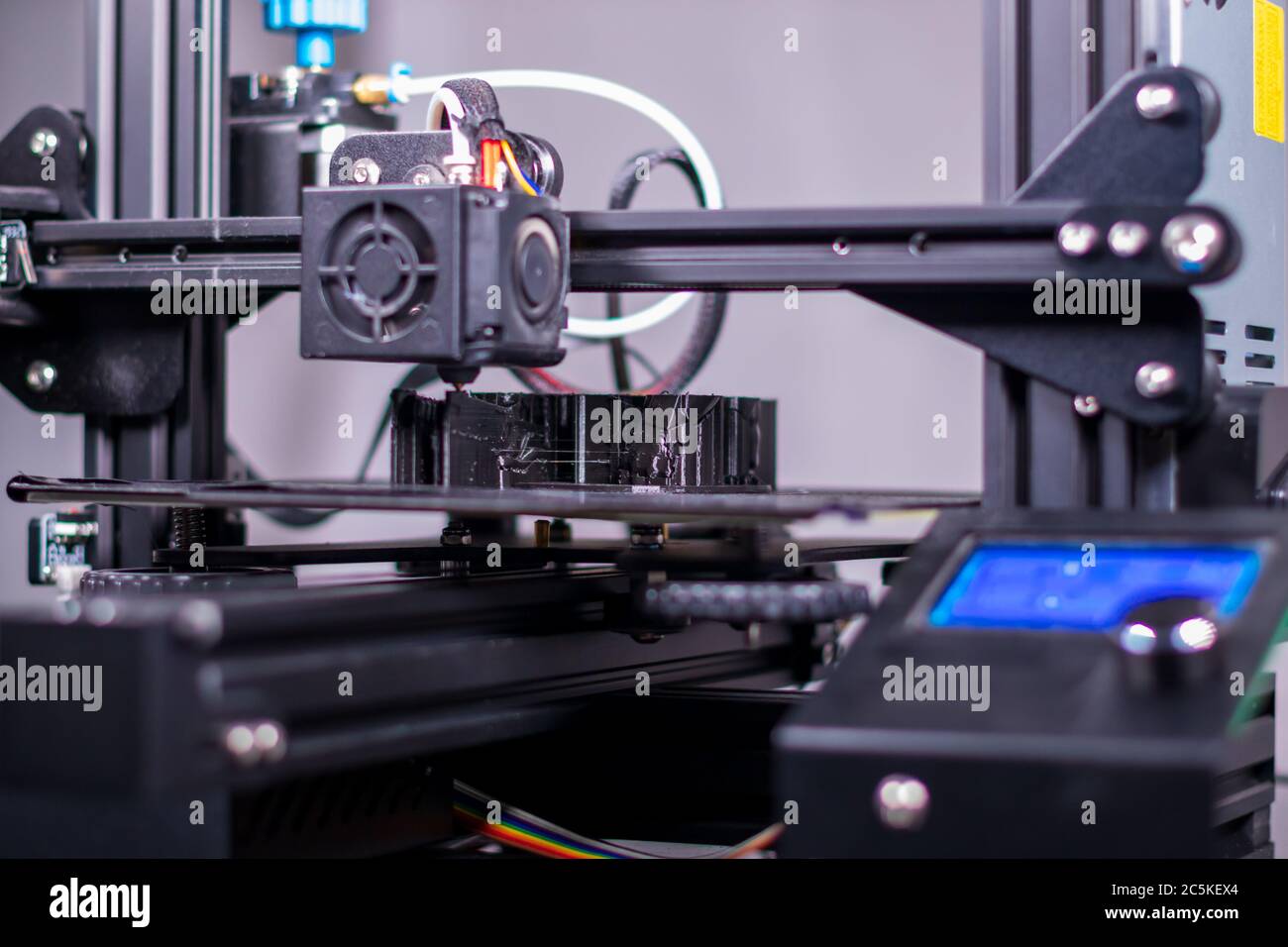 3D plastic printer during work in a factory three dimensional printing. Close-up detail. Stock Photo