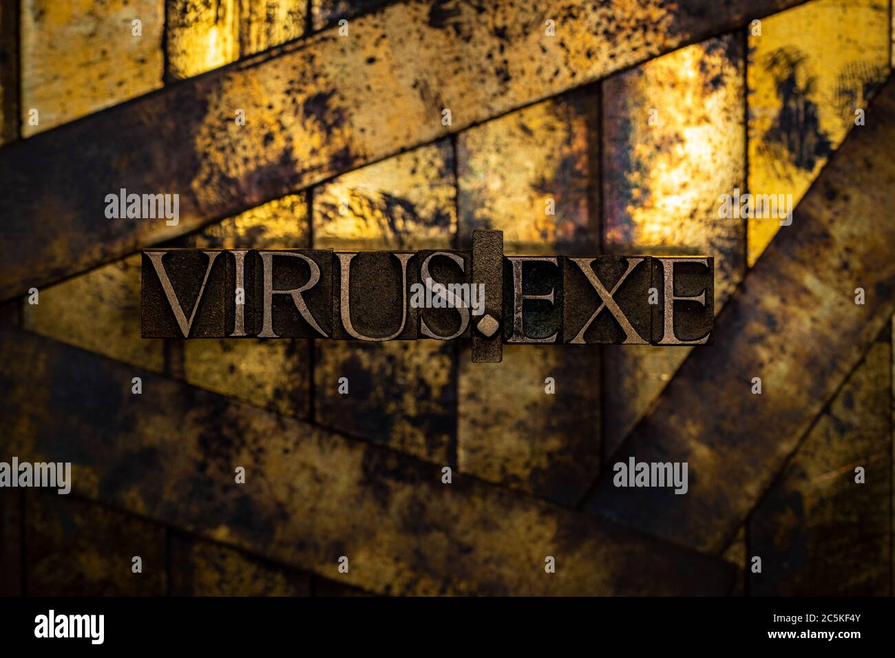Virus.exe text formed with real authentic typeset letters on vintage textured silver grunge copper and gold background Stock Photo