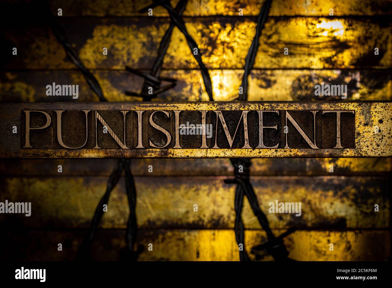 Punishment text formed with real authentic typeset letters on vintage textured silver grunge copper and gold background Stock Photo