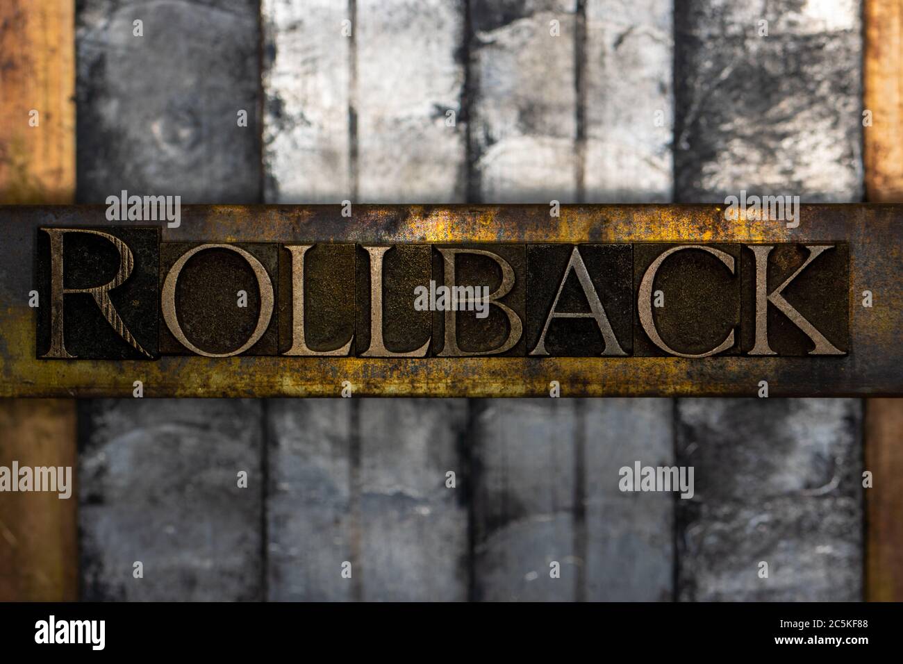 Rollback text formed with real authentic typeset letters on vintage textured silver grunge copper and gold background Stock Photo