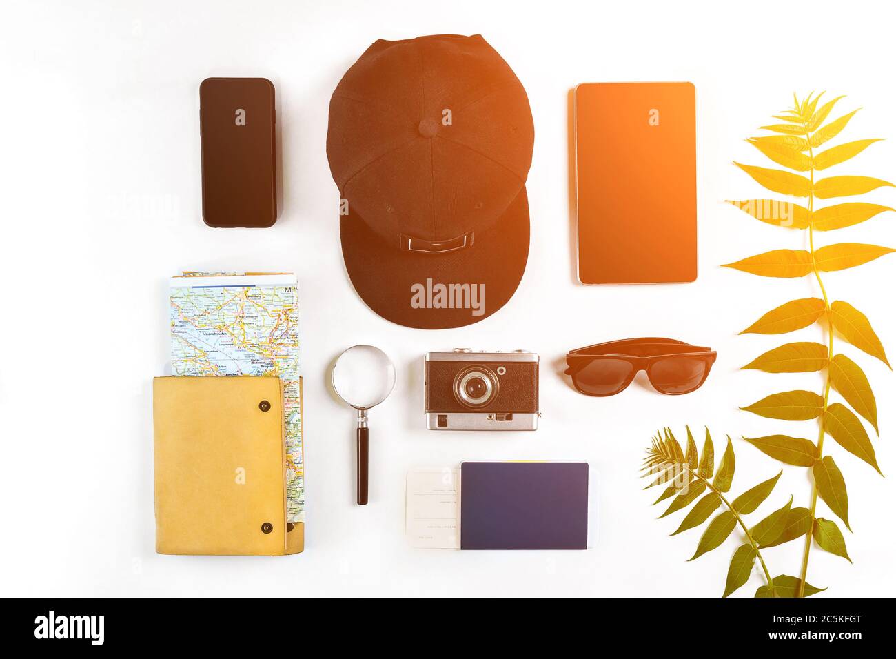 Travel accessories set on white background smart, passport, cap, notepad, map, camera and