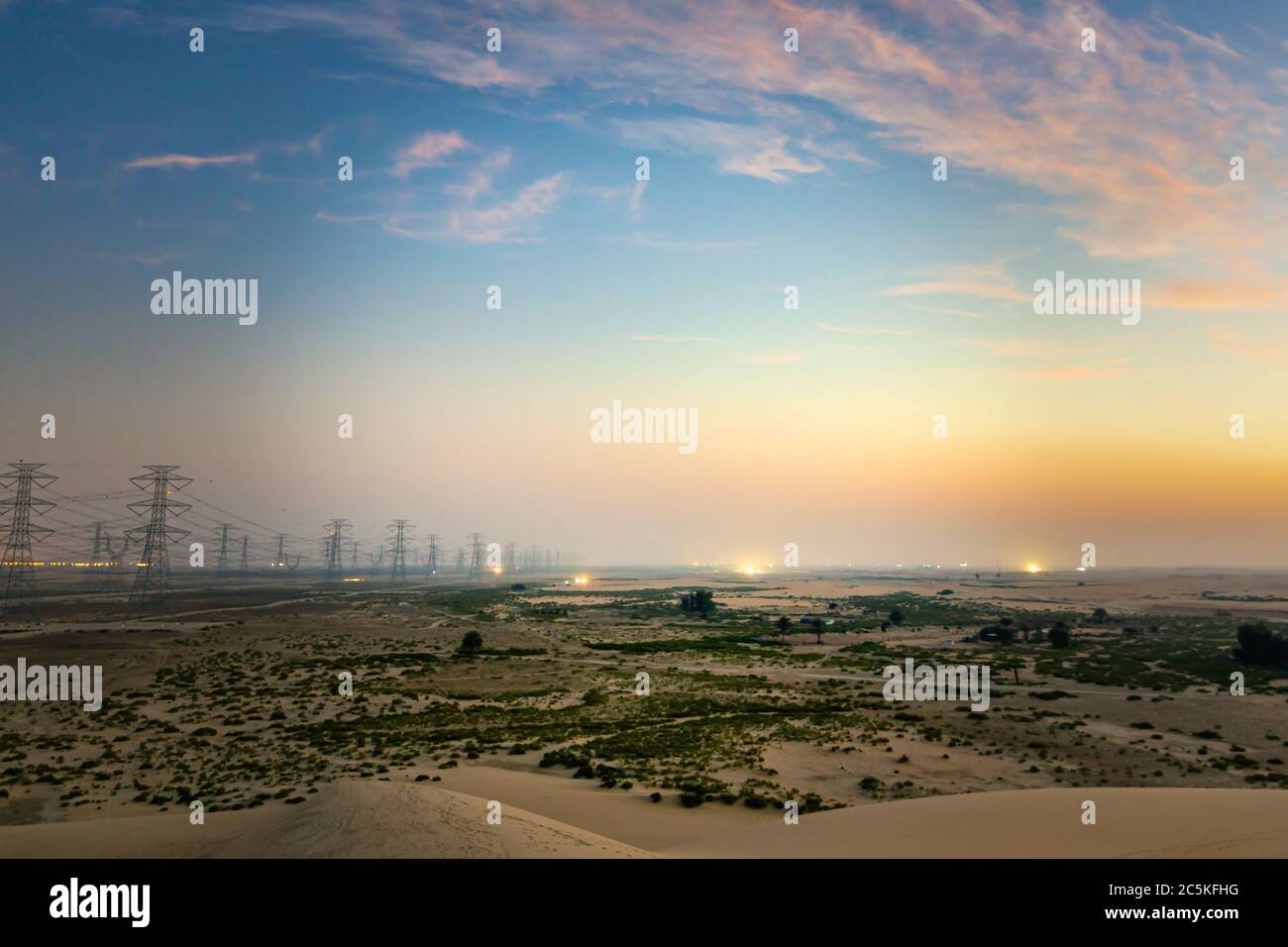 High voltage electric tower on sunrise time near Al Hofuf - Saudi Arabia. Stock Photo
