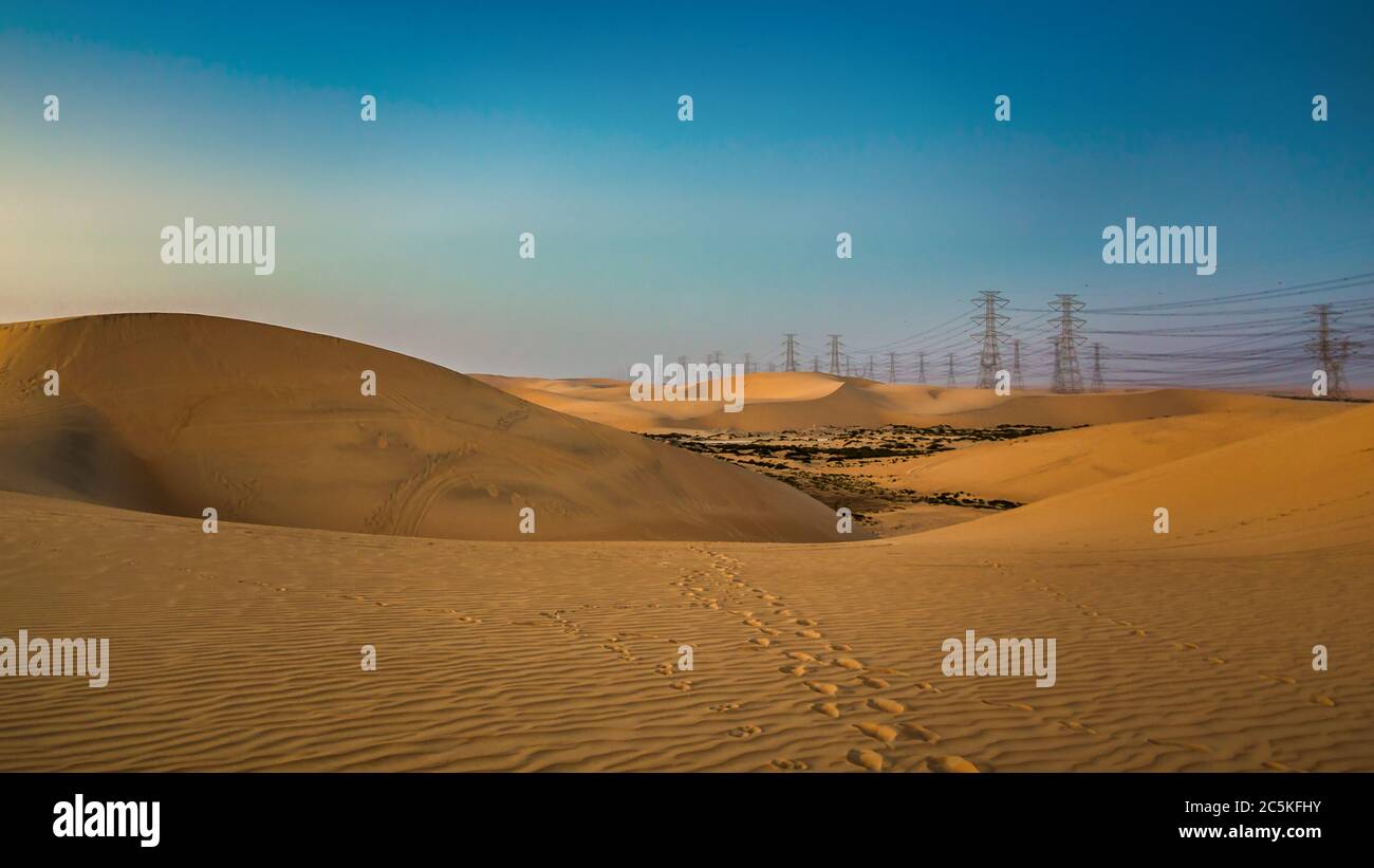 High voltage electric tower on sunrise time near Al Hofuf - Saudi Arabia. Stock Photo