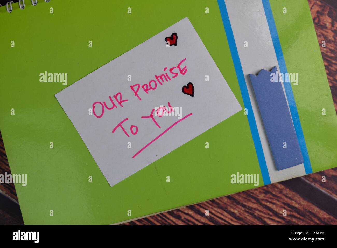 Our Promise To You text on sticky notes isolated on office desk. Stock Photo