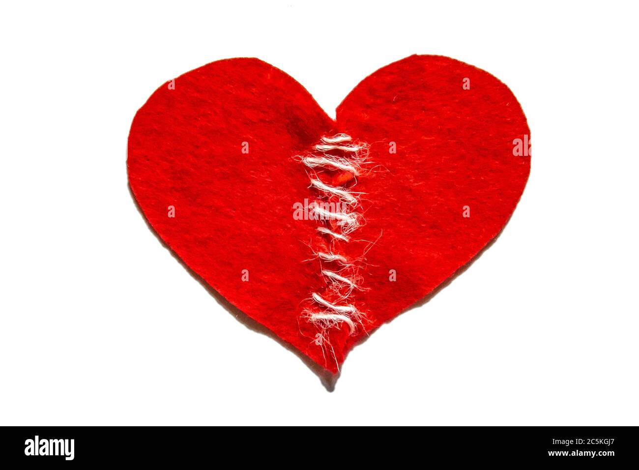 Sewed a broken heart with a thread. Red heart made of felt. Broken love  concept. Fixed heart with thread Stock Photo - Alamy