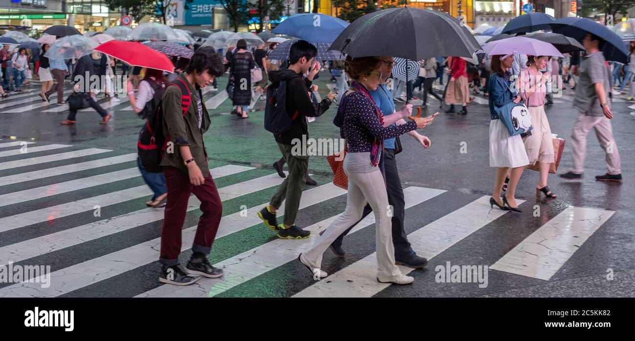 Pedestrian crowd walking across Shibuya scramble crossing during a ...