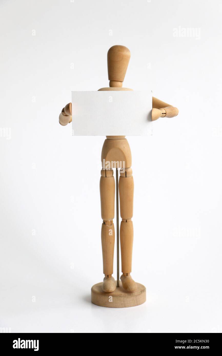 Isolated wood mannequin holding a blank sign Stock Photo