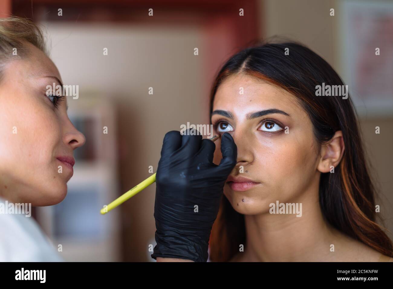 Makeup woman artist at work, professional in action with young model in beauty salon and creative classes Stock Photo