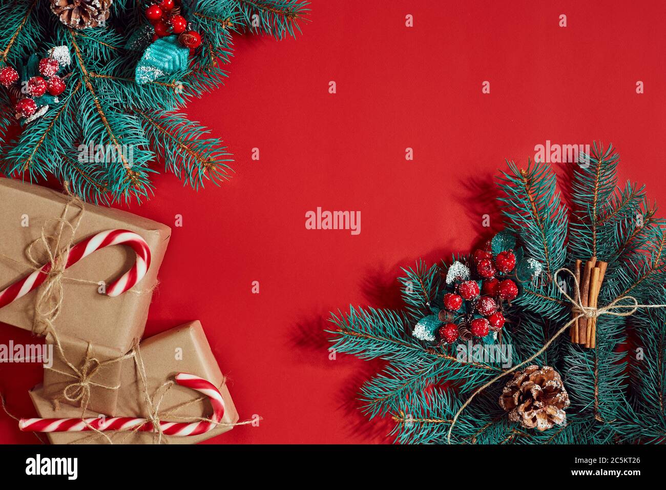 Christmas composition of pine cones, spruce branches and stack of gift ...