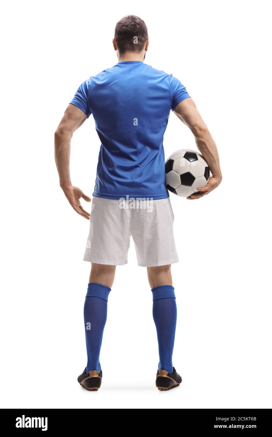 Full length rear shot of a soccer player with a ball under arm isolated