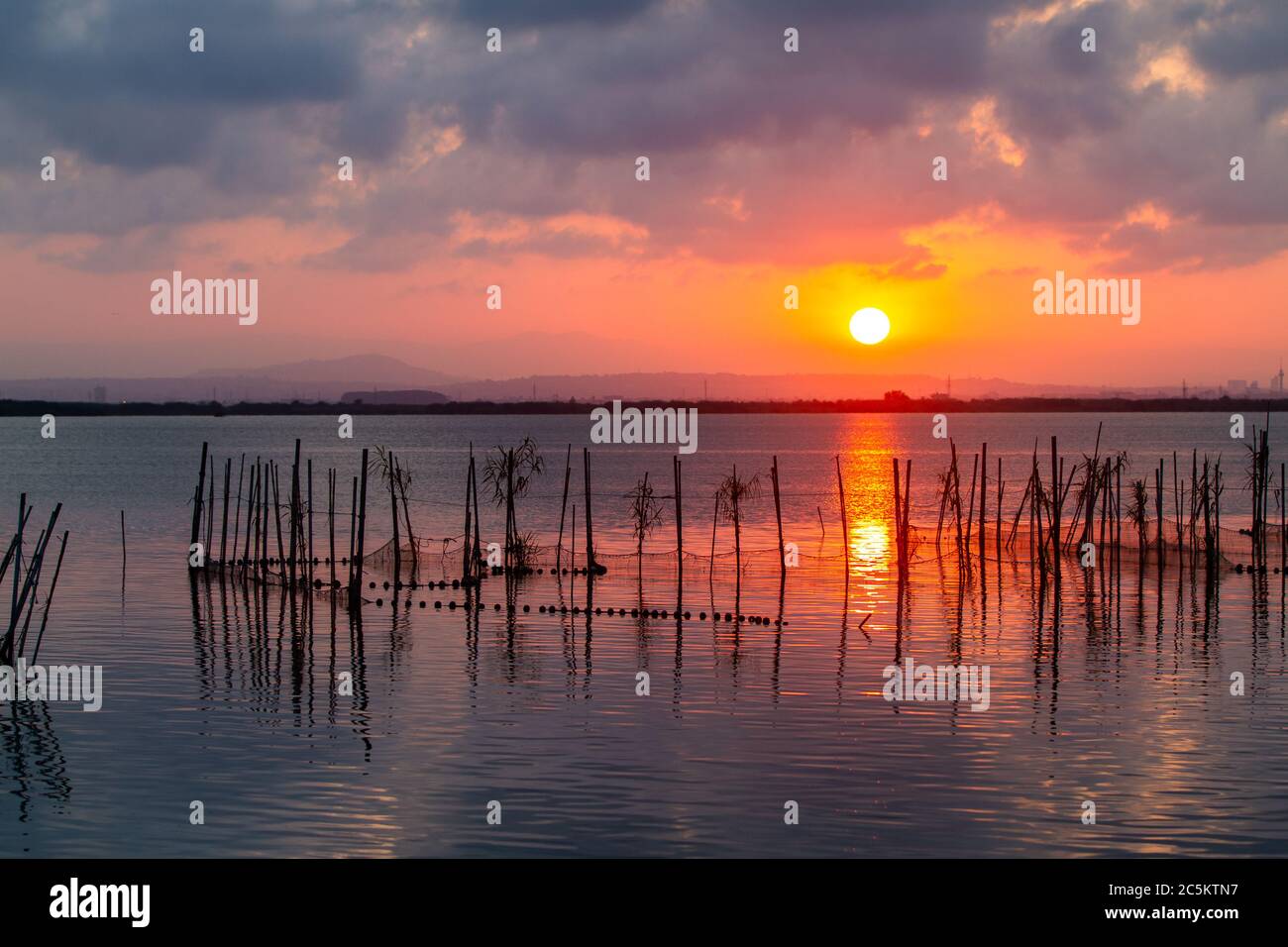 Sunset over Albufera freshwater lagoon and estuary on the Gulf of Valencia  coast, Spain Stock Photo - Alamy