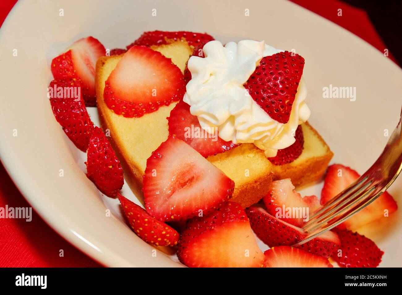 Cake with fresh sliced strawberries and whipped topping Stock Photo Alamy