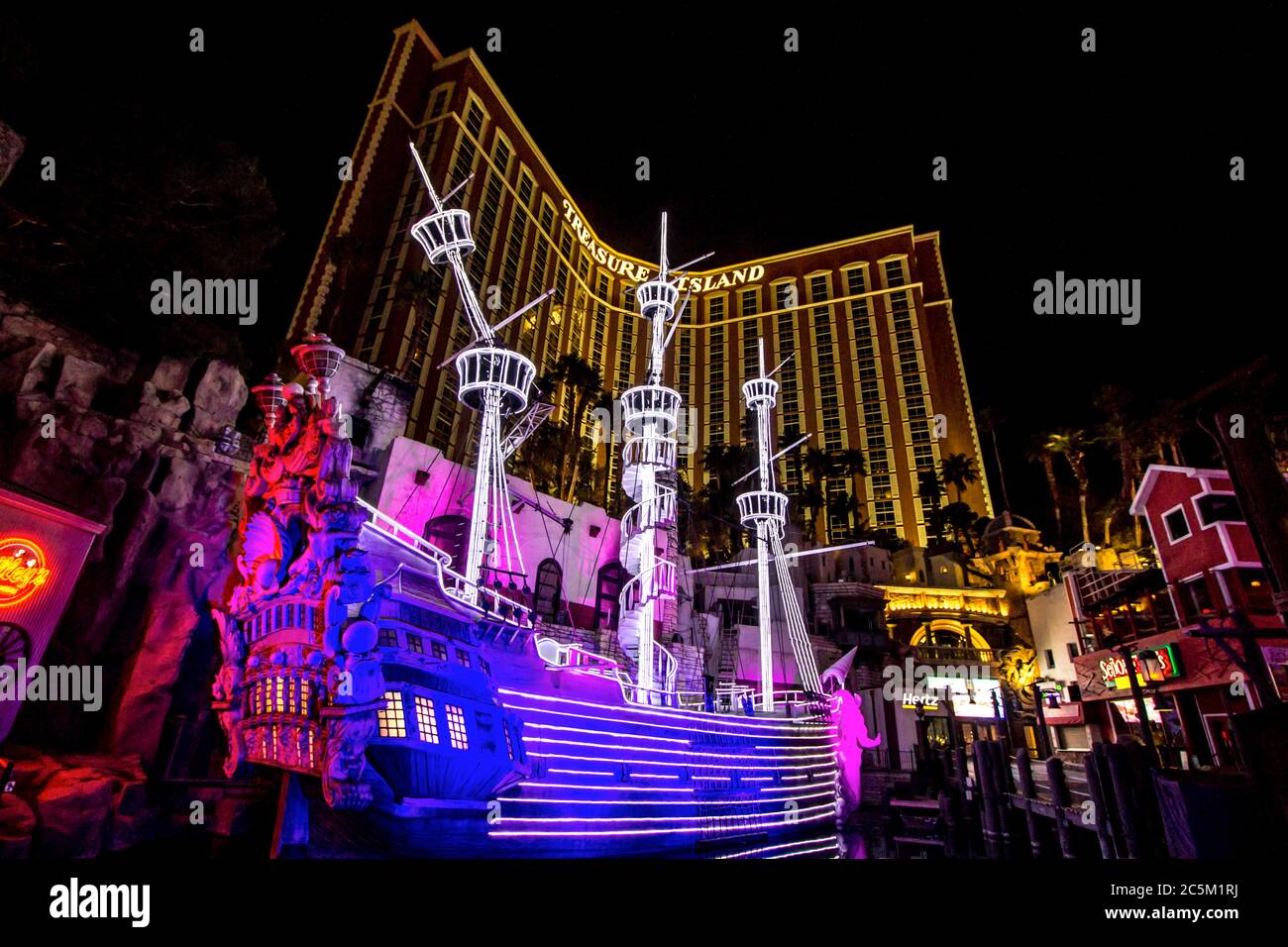 Las Vegas, Nevada, USA - February 20, 2020: Illuminated exterior of the Treasure Island Hotel and Casino completed with pirate ship in Las Vegas Stock Photo