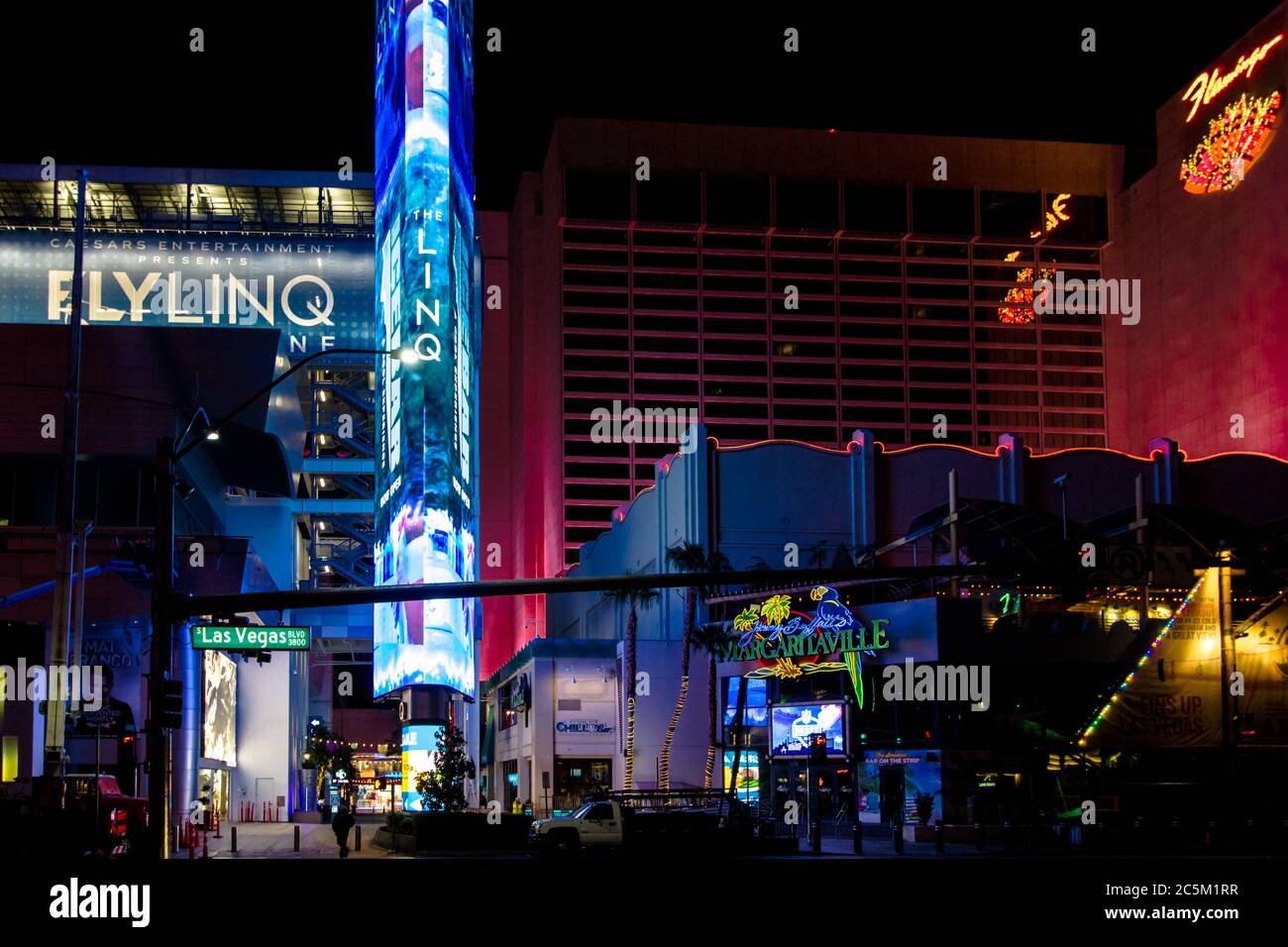 Las Vegas, Nevada, USA - February 20, 2020: Illuminated neon lights of the Las Vegas Strip with street sign for the famous Las Vegas Boulevard. Stock Photo