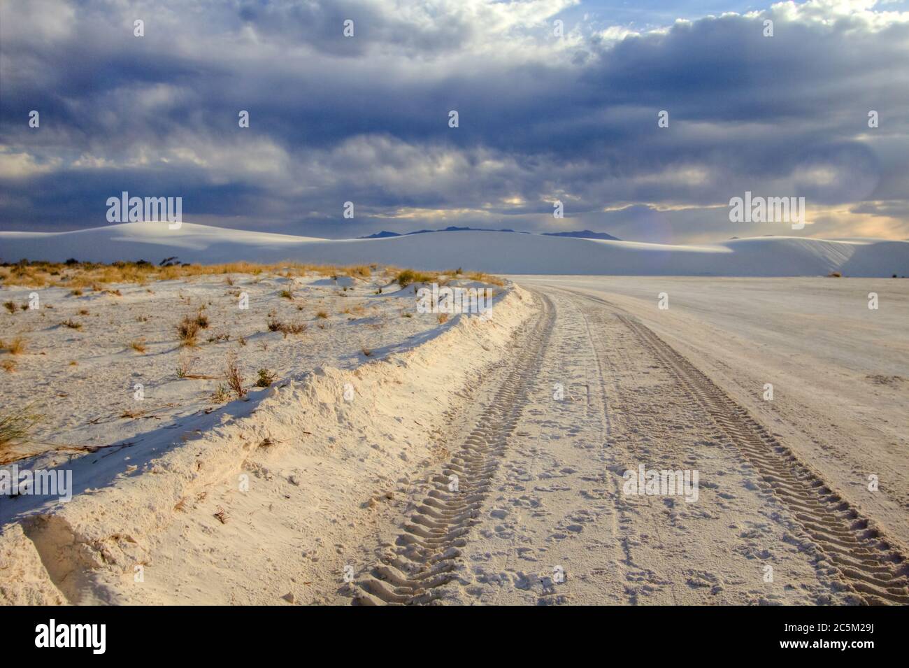 Tire tracks on a remote dirt road through the desert of the White Sands National Monument in Alamogordo, New Mexico. Stock Photo