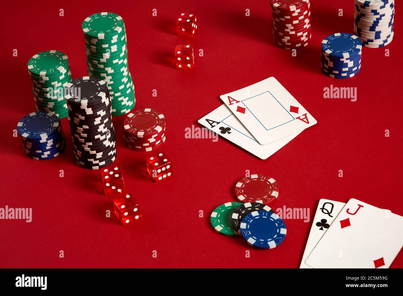 Poker chips and aces on red background. Group of different poker chips