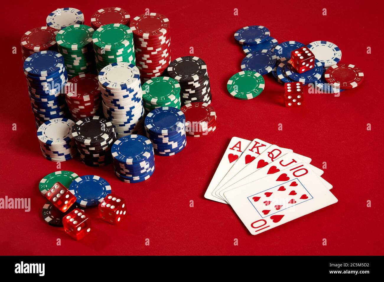 poker equipment and entertainment concept - close up of playing cards and chips red background. Royal flush heart Photo - Alamy
