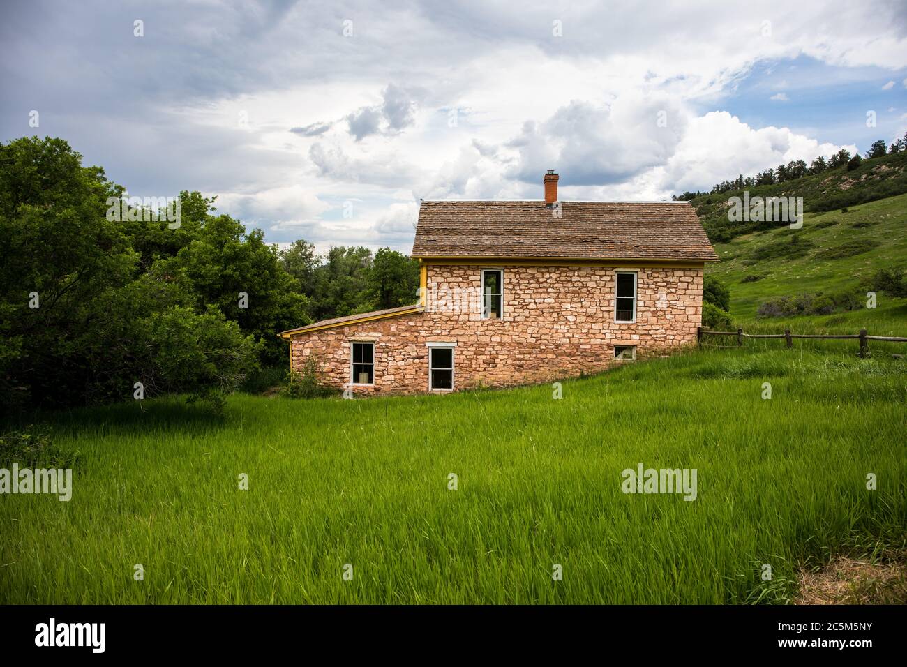 House in the middle of the green field Stock Photo - Alamy