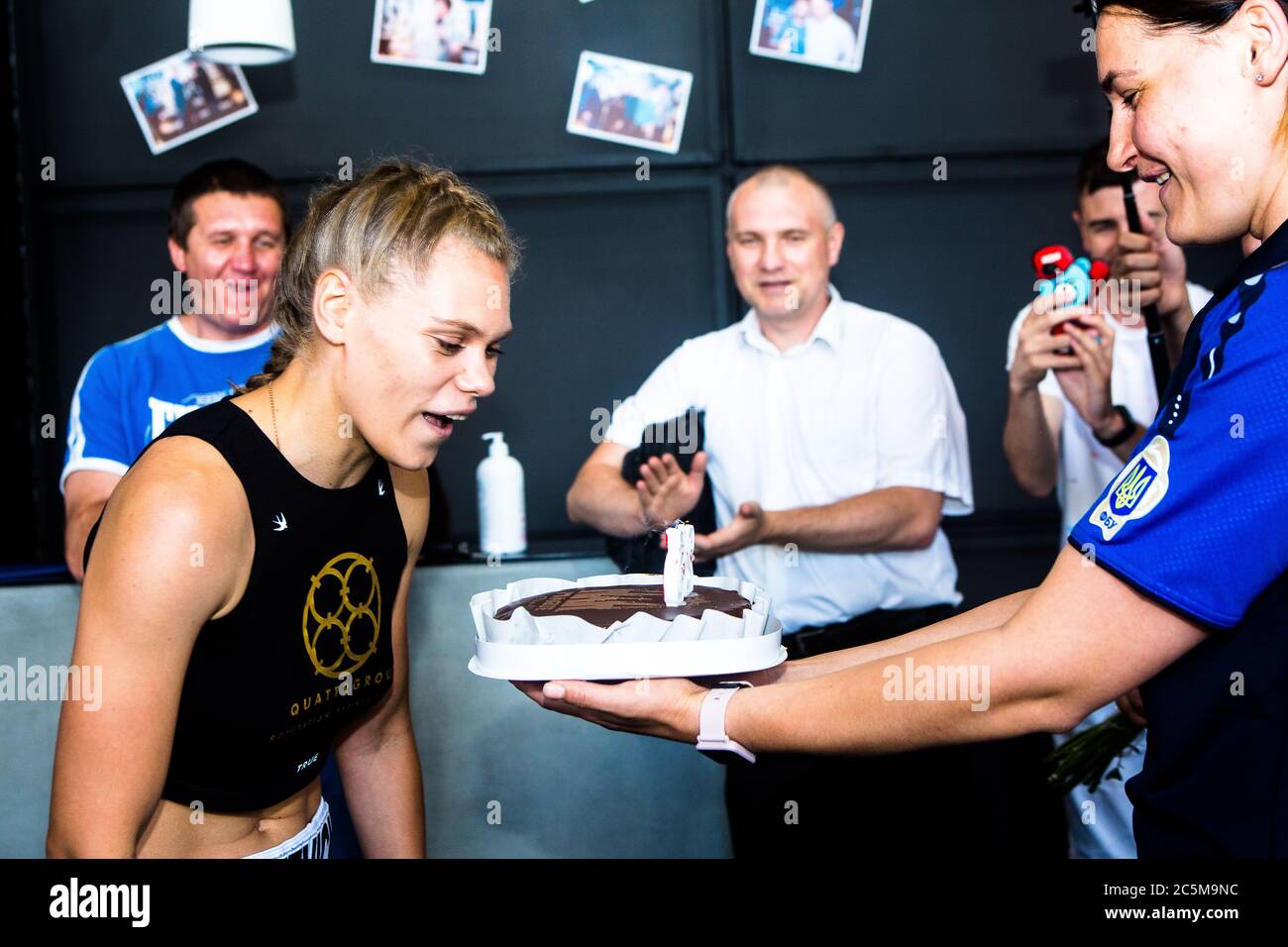 Ukrainian boxing master champion Inna Statkevich celebrates 25th anniversary with boxing friends after successful weighing out at Sparta boxing club. Stock Photo