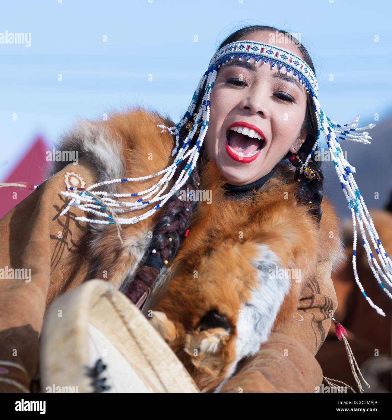 Woman in national clothing indigenous inhabitants Kamchatka dancing with tambourine. Concert