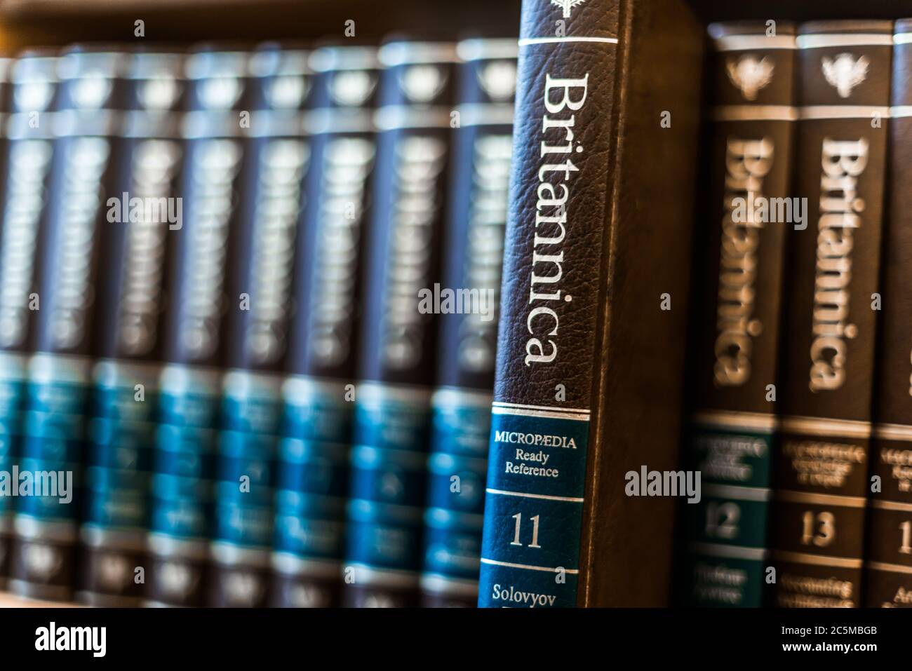 POZNAN, POL - FEB 03, 2020: Encyclopedia Britannica volumes on a shelf in a public library Stock Photo