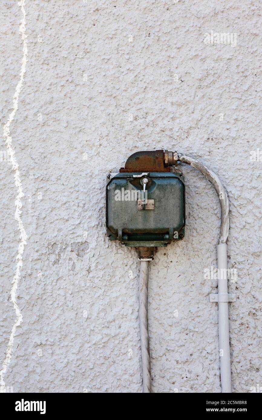 old three phase on worn stone wall Stock Photo