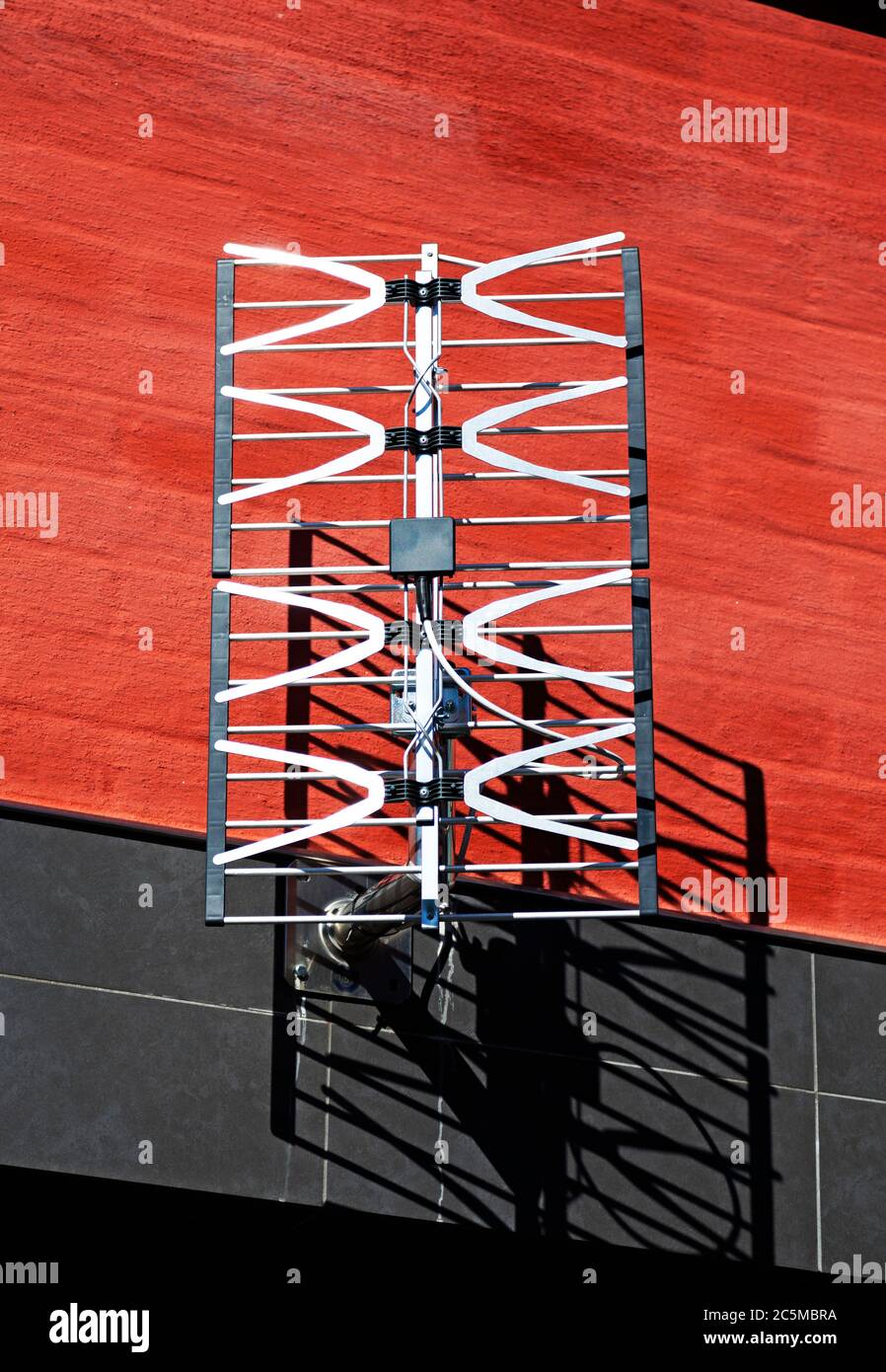 tv antenna mounted on red brick house Stock Photo Alamy