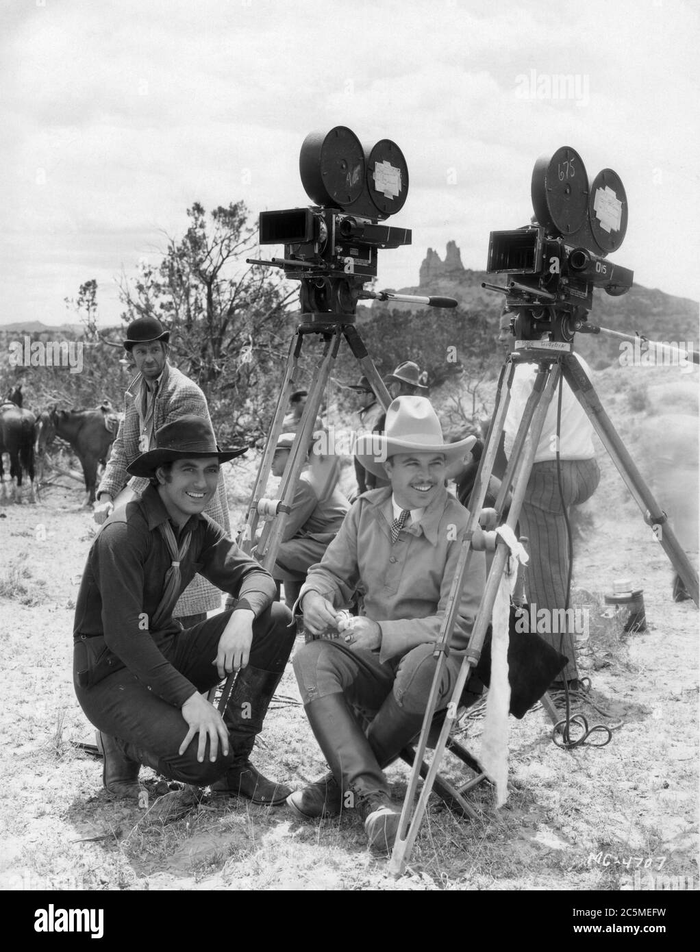 JOHNNY MACK BROWN and Director KING VIDOR with ROSCOE ATES and movie crew  on set location candid with 35mm and 70mm movie cameras during filming of  BILLY THE KID 1930 book Walter