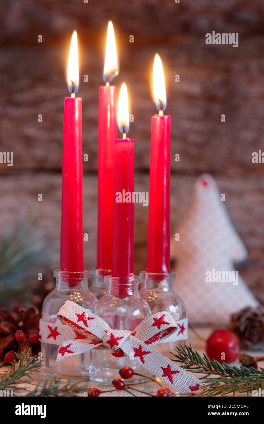 christmas decoration with red advent candles in glass bottles Stock