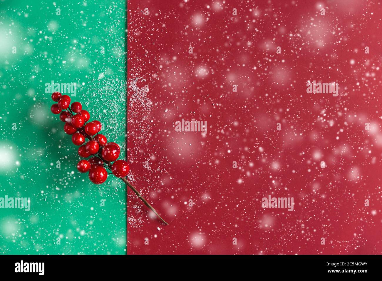 Christmas branch decoration with red berries on a red and green ...