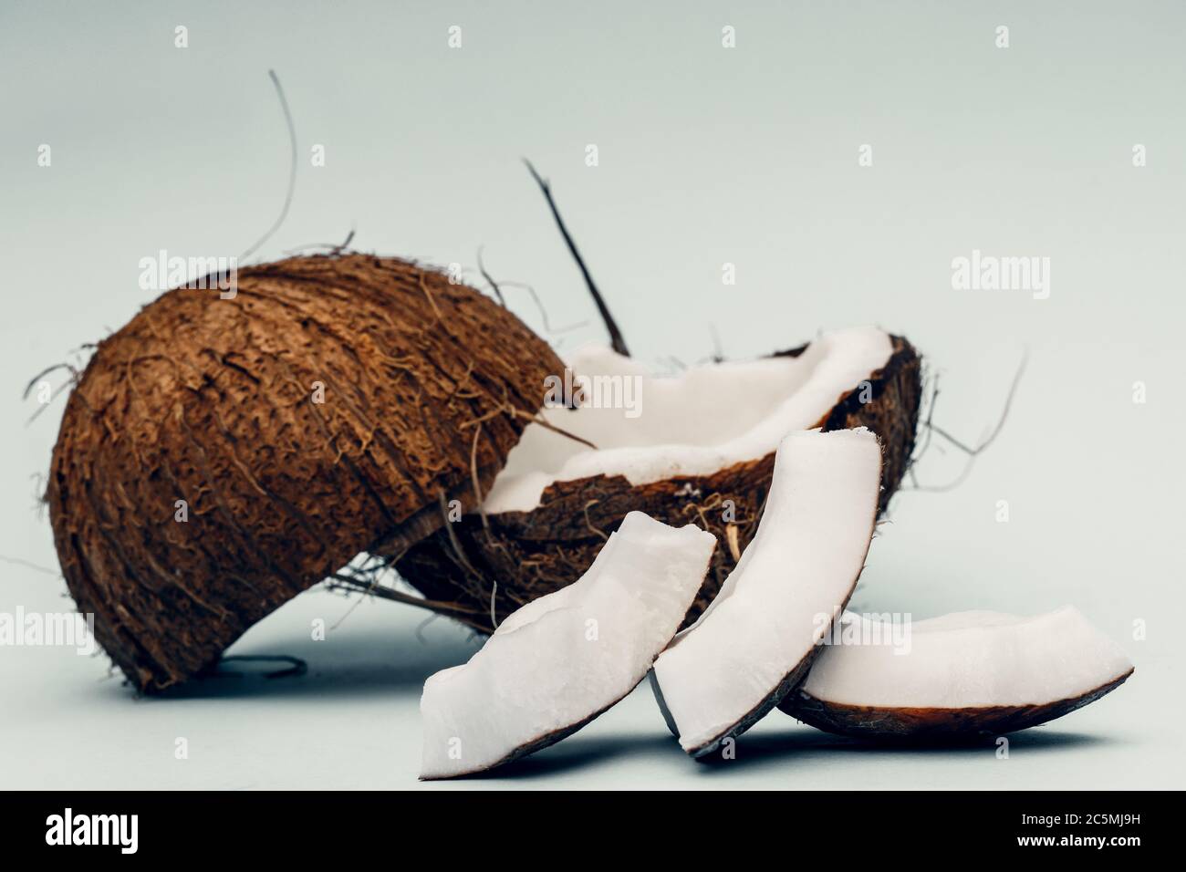 Parts of coconut on a colored background. Close up. Fresh ripe coconut ...