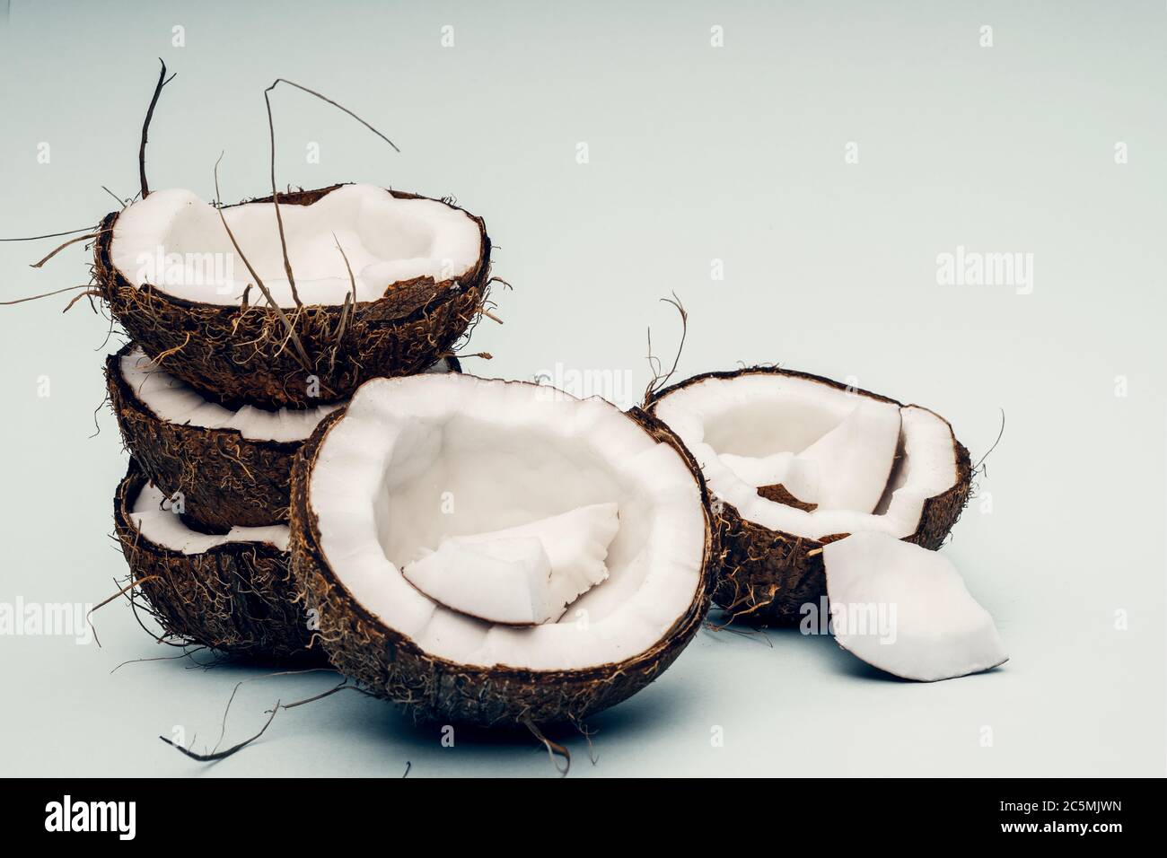 Parts of coconut on a colored background. Close up. Fresh ripe coconut ...