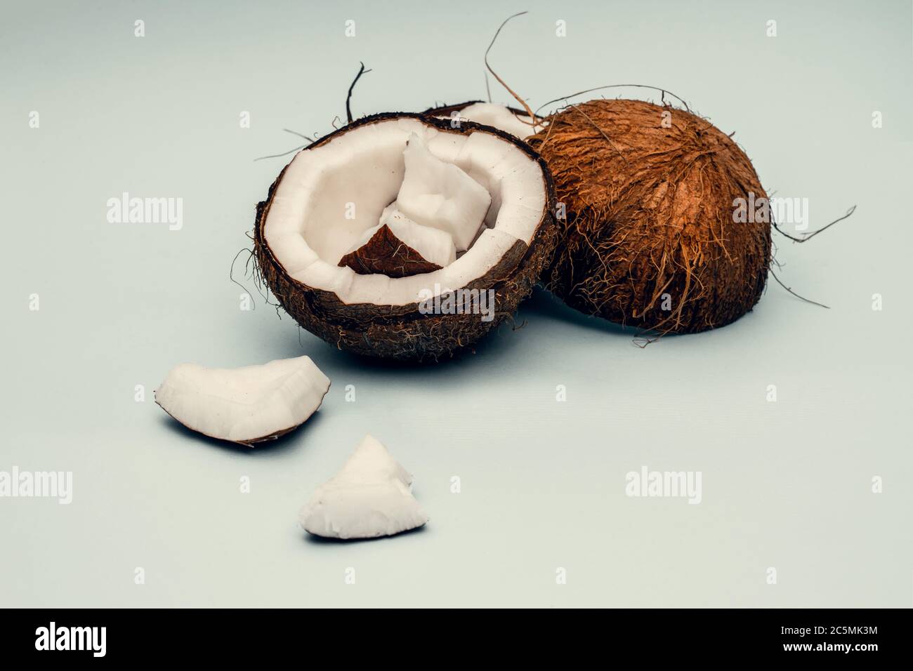 Parts of coconut on a colored background. Close up. Fresh ripe coconut ...
