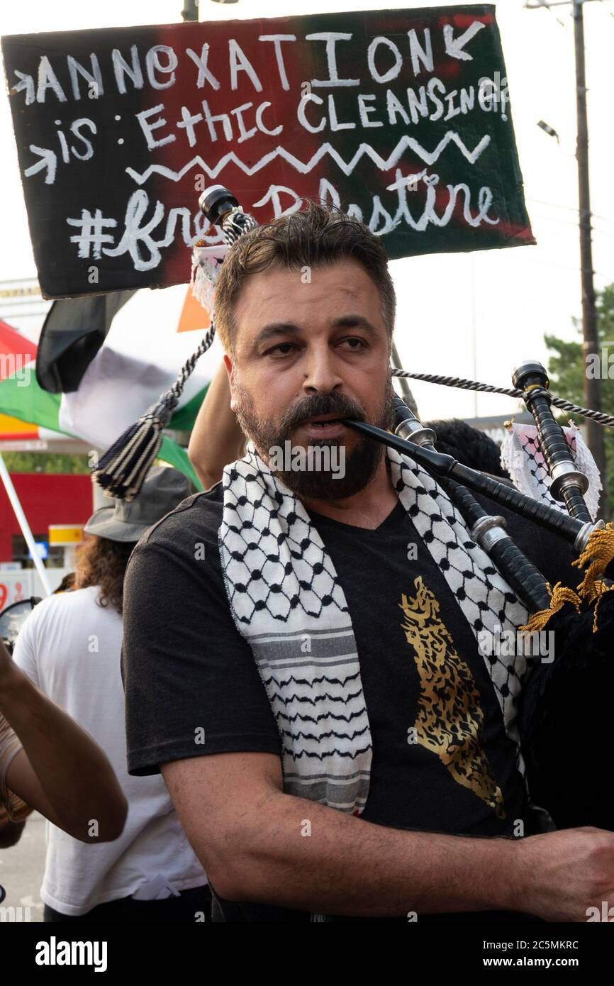 Atlanta, USA. 3rd Jul, 2020. A protester is playing Palestinian music on a Middle Eastern bagpipe while protesting the illegal annexation of Palestinian land on Spring Street in Atlanta, USA. Credit: Micah Casella/Alamy Live News. Stock Photo