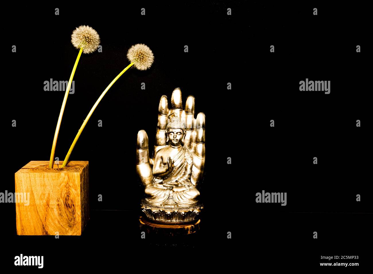 Buddha statue on black background with candles Stock Photo Alamy