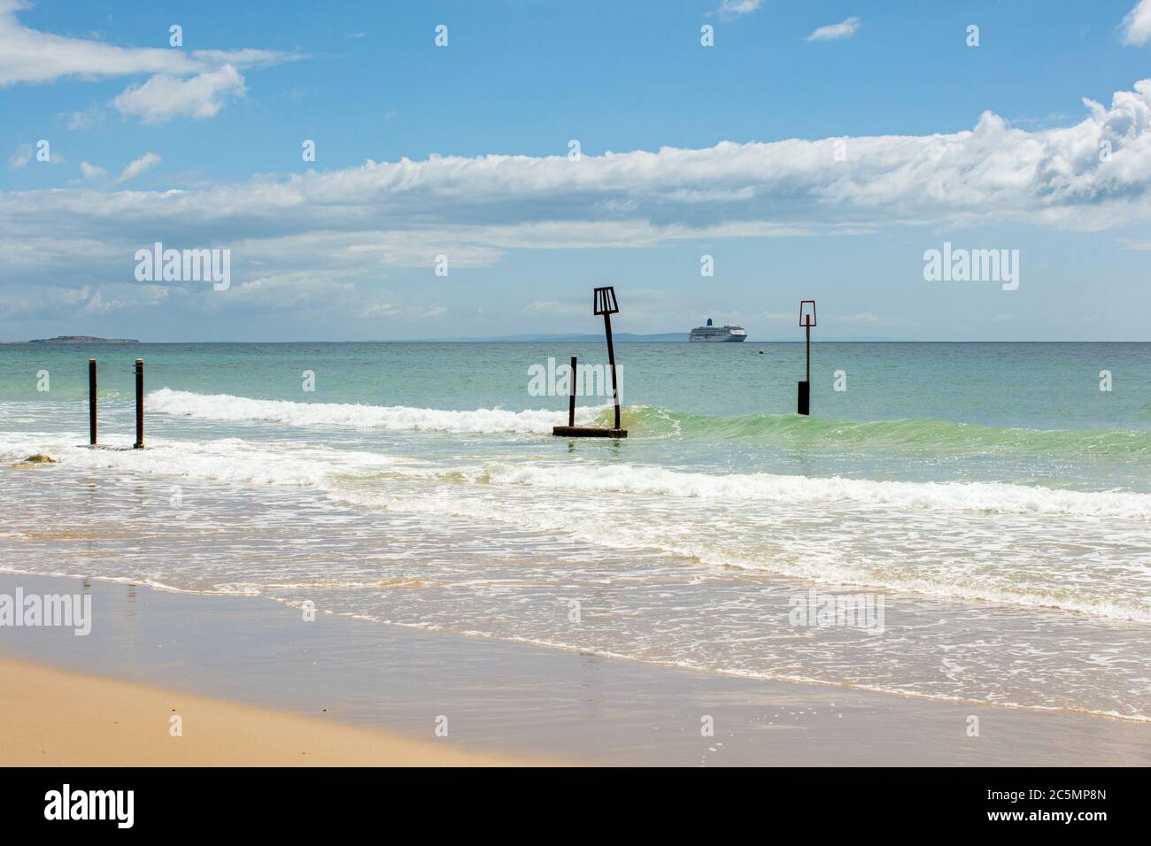Cruise ship anchored off the coast of the Isle of Wight during the coronavirus outbreak in 2020 as seen from Branksome Chine Beach, Poole, Dorset, UK Stock Photo