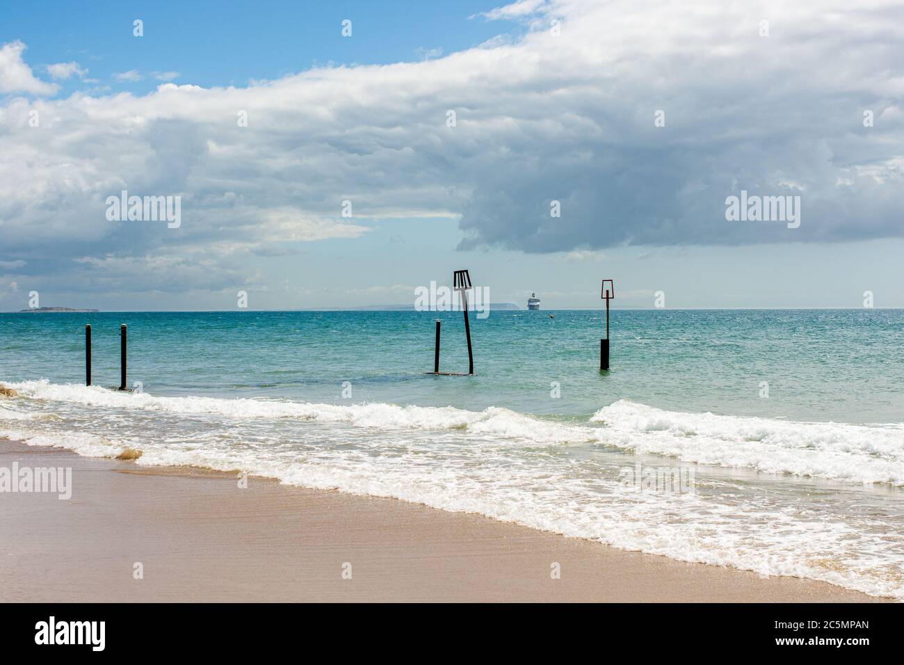 Cruise ship anchored off the coast of the Isle of Wight during the coronavirus outbreak in 2020 as seen from Branksome Chine Beach, Poole, Dorset, UK Stock Photo