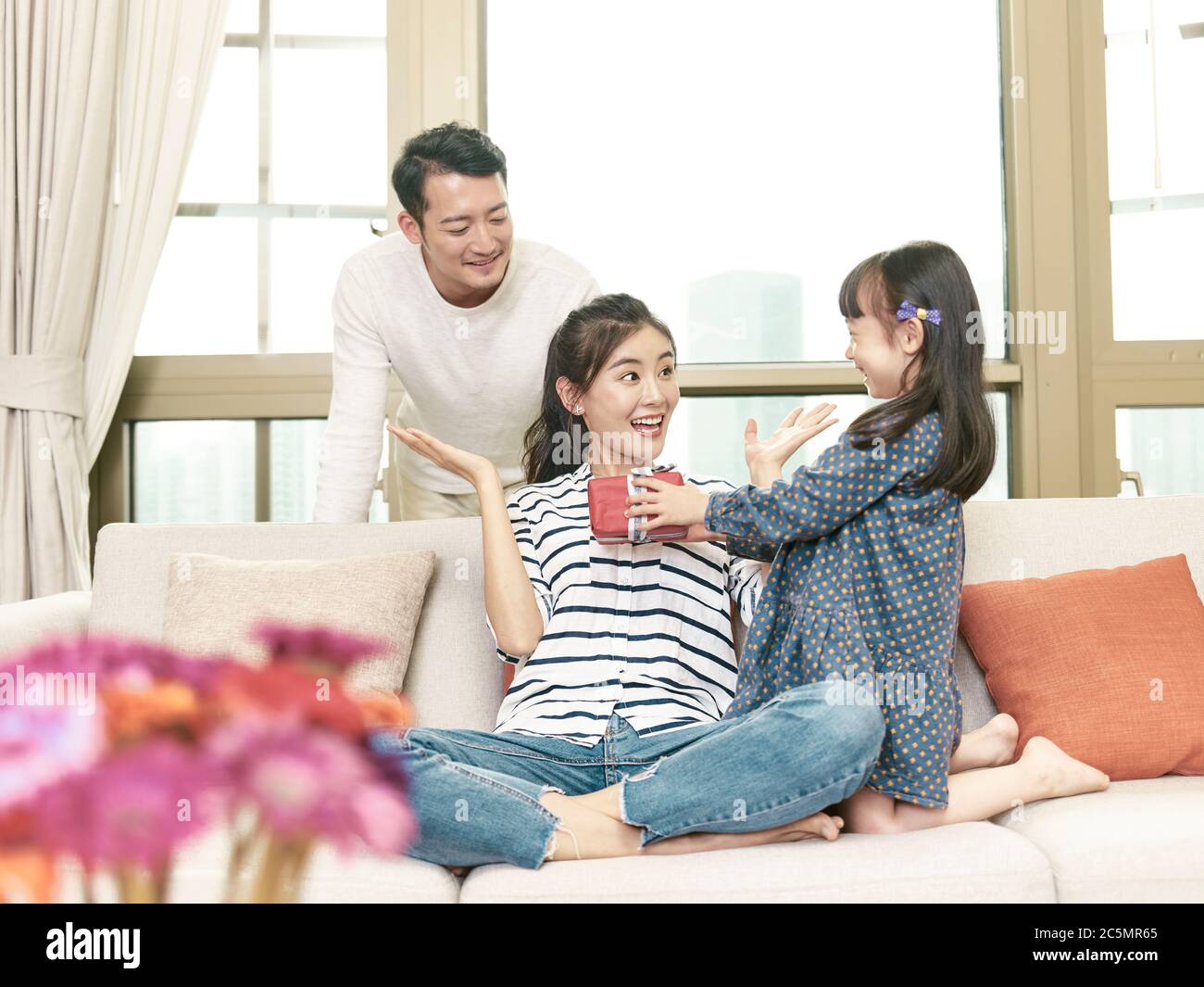 young asian woman receiving a gift from daughter on mother's day Stock Photo