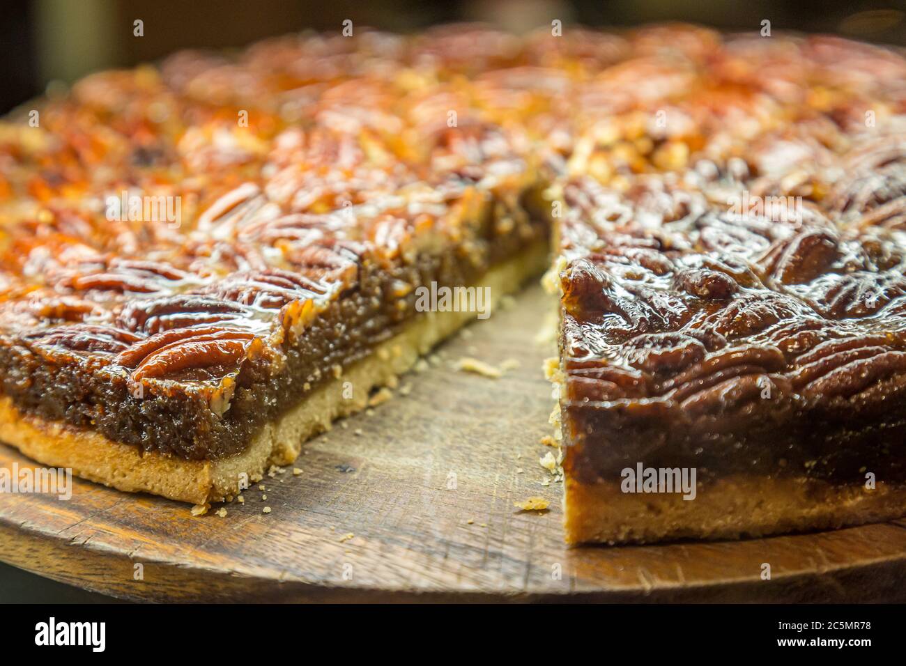 A pecan pie for sale with a slice removed Stock Photo Alamy