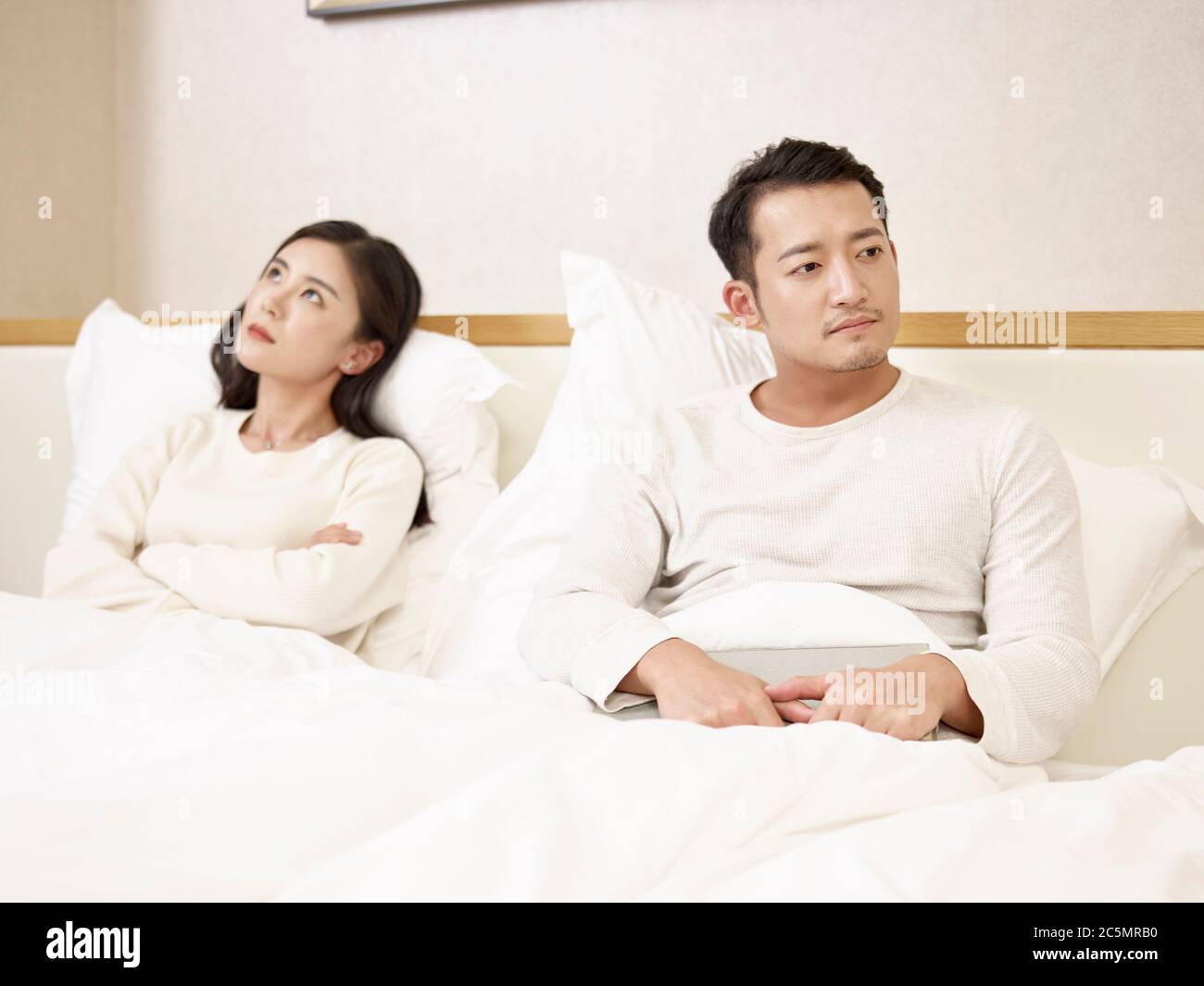 young asian couple unhappy and angry with each other after an argument or fight Stock Photo